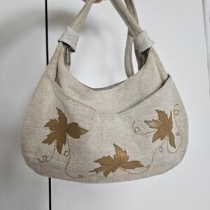 Cream canvas boho crescent shoulder bag with tan leather leaves embroidered